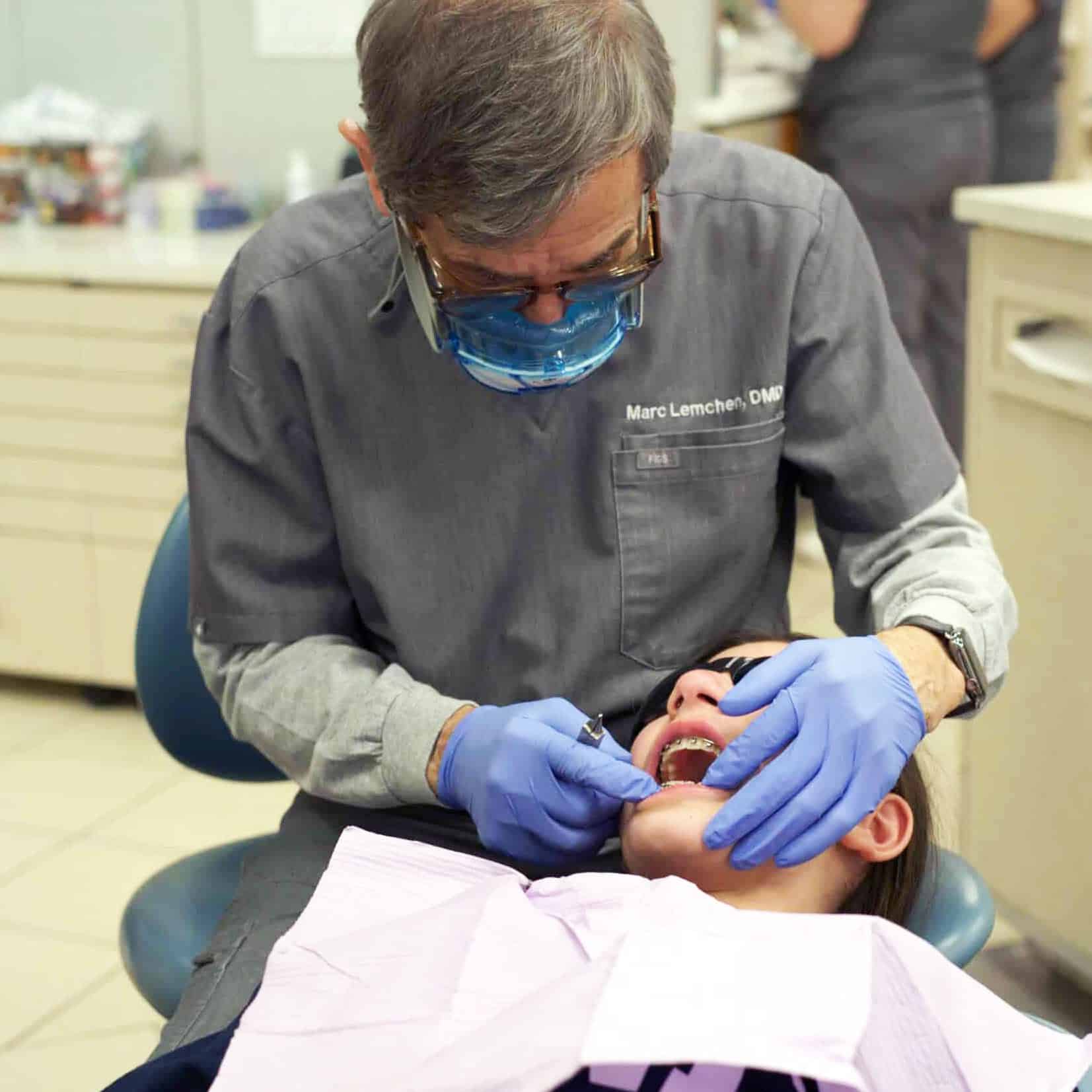 Orthodontist examining a patient’s bite during open bite treatment in NYC