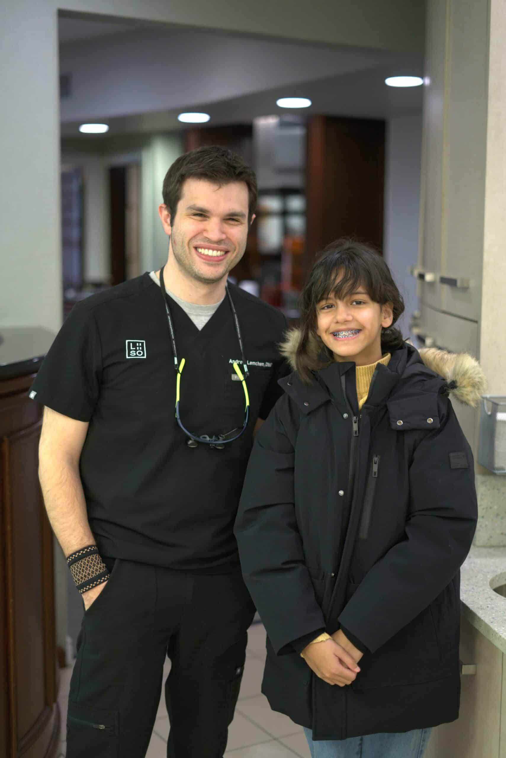 Orthodontist standing with a patient after a braces appointment at Lemchen Salzer Orthodontics, a premium braces NYC practice