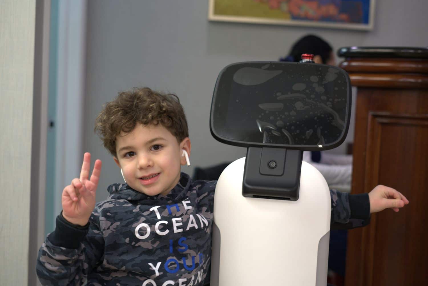 Young patient meeting Zeeno, one of the dental robots NYC kids love at Lemchen Salzer Orthodontics