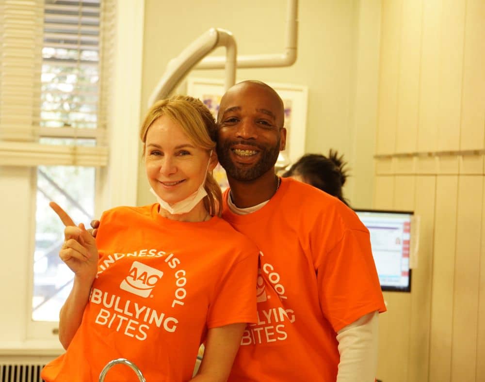 Team members in matching orange shirts at an orthodontist New York City families visit on Park Avenue